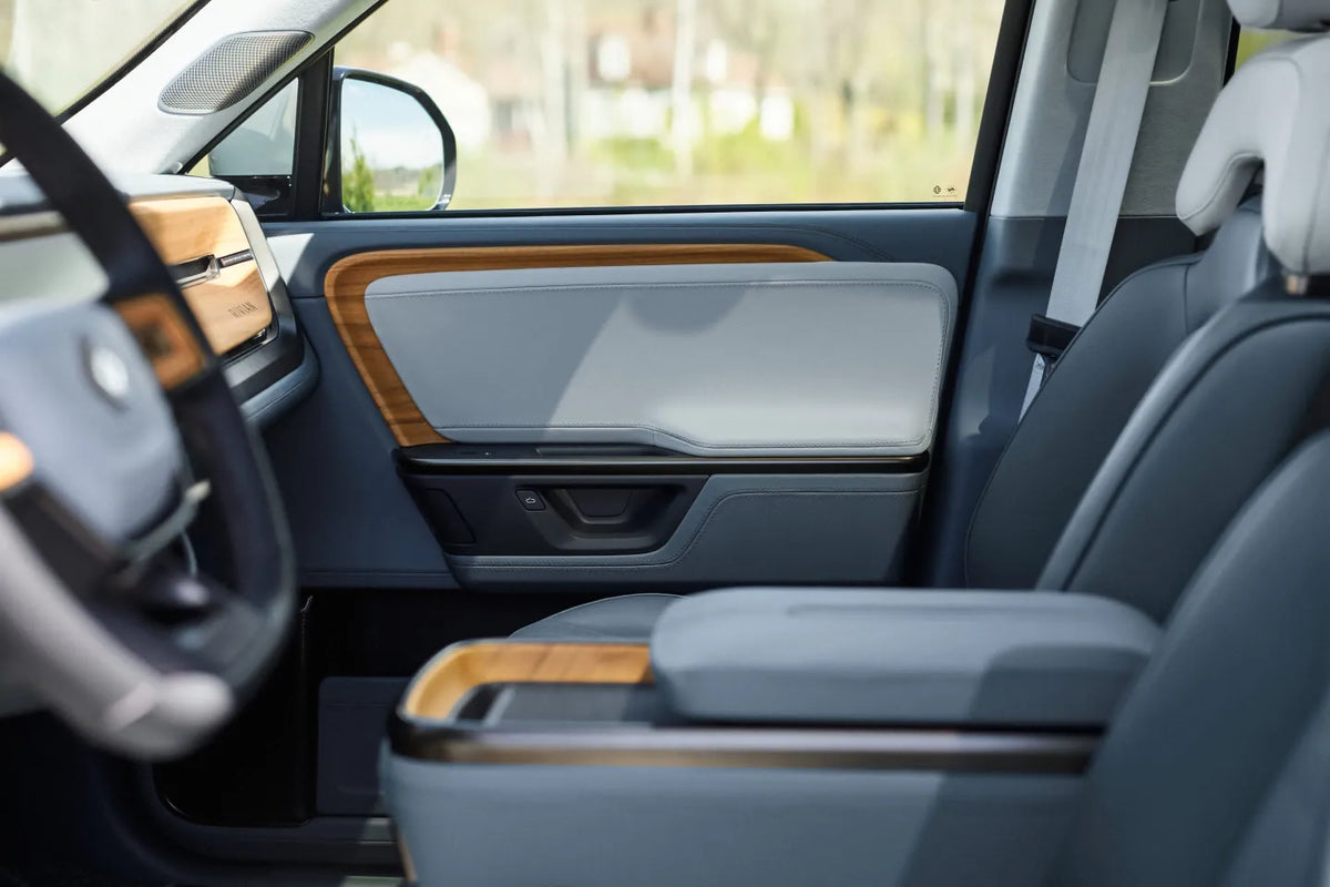 Rivian front passenger seat, center console, and door panel with wood trim